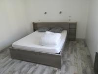 a bed with white sheets and pillows in a room at Paranthese à Marennes in Marennes