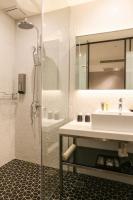 a bathroom with a shower and a sink and a mirror at City Suites - Taipei Nandong in Taipei