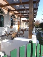 a patio with tables and chairs and a wooden pergola at Sheep House B&amp;B in Ji&#39;an