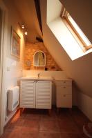 a attic bathroom with a sink and a skylight at Le Domaine des Fargues in Sainte-Foy-de-Longas