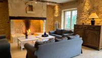 a living room with two couches and a fireplace at Le Domaine des Fargues in Sainte-Foy-de-Longas