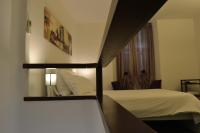 A bed or beds in a room at Palazzo Velli Suites