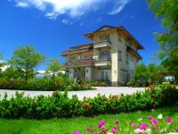 a large house with flowers in front of it at Elegance House in Wujie
