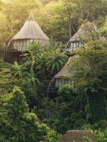 a group of huts in a forest with trees at Keemala in Kamala Beach