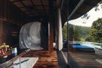 a house with a view of a swimming pool at Keemala in Kamala Beach