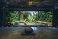 a room with a pool of water in a forest at Keemala in Kamala Beach
