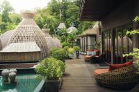 a resort with a pool and a deck with wicker chairs at Keemala in Kamala Beach
