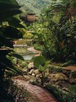 a garden with a walkway in the middle at Keemala in Kamala Beach
