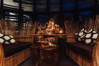 a room with two chairs and a table with candles at Keemala in Kamala Beach