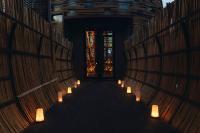 a row of candles in a room with a hallway at Keemala in Kamala Beach