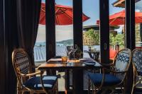a table with chairs and an umbrella on a patio at Keemala in Kamala Beach