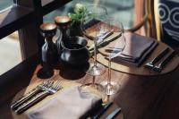 a table with wine glasses and utensils on a table at Keemala in Kamala Beach