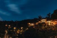a building on a hill at night at Keemala in Kamala Beach