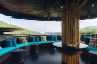a room with blue couches and a large window at Keemala in Kamala Beach