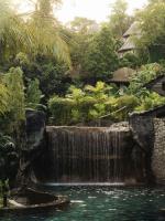 a waterfall in the middle of a garden at Keemala in Kamala Beach