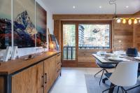 a kitchen with a table and a dining room at Apartment Brevent Fodera in Chamonix
