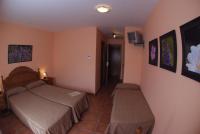 A bed or beds in a room at Hotel Casa Duaner
