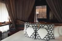 a bedroom with a bed with two pillows on it at Keemala in Kamala Beach