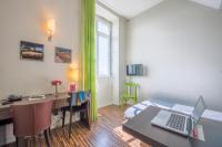 a room with a desk and a bed with a laptop at Résidence Villemanzy in Lyon