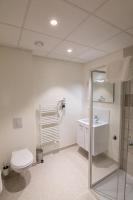 a bathroom with a toilet and a sink at Tulip Inn Thionville Residences in Thionville