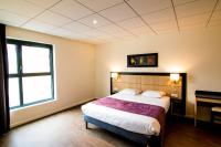 a bedroom with a large bed and a window at Tulip Inn Thionville Residences in Thionville