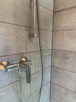 a shower with a faucet in a bathroom at Hotelski in Verbier