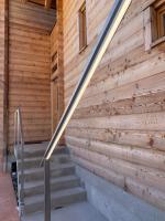 a wooden wall with stairs in front of a building at Hotelski in Verbier
