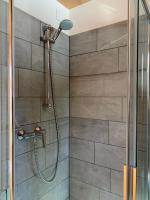a shower in a bathroom with a glass door at Hotelski in Verbier