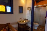 a bathroom with a sink and a toilet at Pousada DiMari in Boicucanga