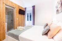 Postel nebo postele na pokoji v ubytování Apartments Fiorello