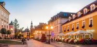 una calle de la ciudad con edificios y gente caminando por la calle en Hotel Restauracja Caspar, en Jelenia Góra
