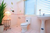 a pink bathroom with a toilet and a sink at Winter&#39;s Love in Wujie