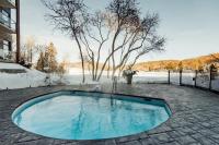 a swimming pool in the middle of a yard at Entourage sur-le-Lac in Lac-Beauport