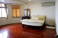 a bedroom with a bed and a mirror on a wooden floor at TopHome 9 in Jiufen