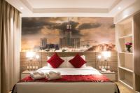 a bedroom with a large bed with a city painting on the wall at Hibatullah Hotel Makkah in Makkah
