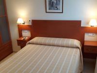 A bed or beds in a room at Hostal Forum
