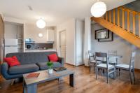 a living room with a couch and a table at Zenitude Hôtel-Résidences Nantes Métropole in Nantes