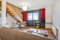 a living room with a couch and a table at Zenitude Hôtel-Résidences Nantes Métropole in Nantes