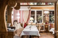 a dining room with a white table and chairs at Aries Hotel & SPA Wisła in Wisła