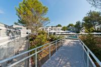 a walkway leading to a pool at a resort at Golden Tulip Sophia Antipolis - Hotel &amp; Spa in Valbonne