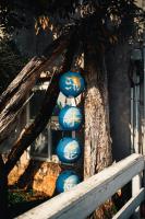 a group of blue spheres hanging from a tree at Blue Lagoon in Huxi