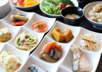 a group of white dishes filled with different types of food at Urban Hotel Minami Kusatsu in Kusatsu