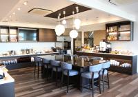 a restaurant with a bar with blue stools at Urban Hotel Minami Kusatsu in Kusatsu