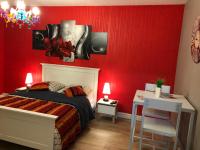 a bedroom with red walls and a bed and a desk at Chambres privées Calais Ferry-Port-Place d&#39;armes in Calais