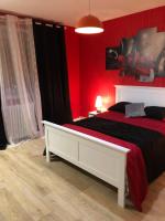 a bedroom with red walls and a white bed at Chambres privées Calais Ferry-Port-Place d&#39;armes in Calais