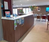 a bar in a restaurant with chairs and tables at Campanile Bayeux in Bayeux