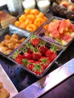 a bunch of strawberries and other fruits in trays on a counter at Campanile Bayeux in Bayeux