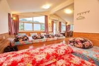 a room with three beds and pillows on the floor at Liang Chen Mei Jin B&amp;B in Shuangxi