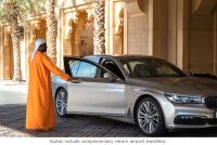 a man in an orange robe standing next to a car at Jumeirah Mina Al Salam Dubai in Dubai