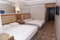 A bed or beds in a room at Hotel Grand Umit